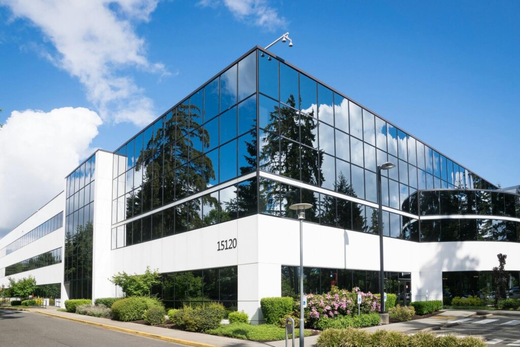 pexels photo 269077 269077 Contemporary office building in Redmond with reflective glass and lush greenery, captured on a sunny day.